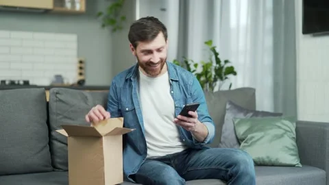 Happy satisfied customer received order in parcel cardboard box and leave review Stock Footage 222778264
