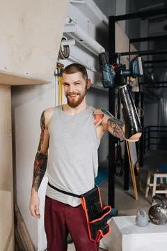 Happy satisfied cyborg man with bionic hand posing with electric screwdriver Stock Photos