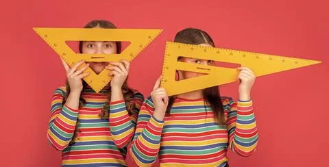 Happy school students hold math tool of triangle Stock Photos