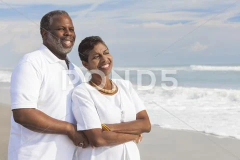 Happy senior african american couple on beach Stock Photos