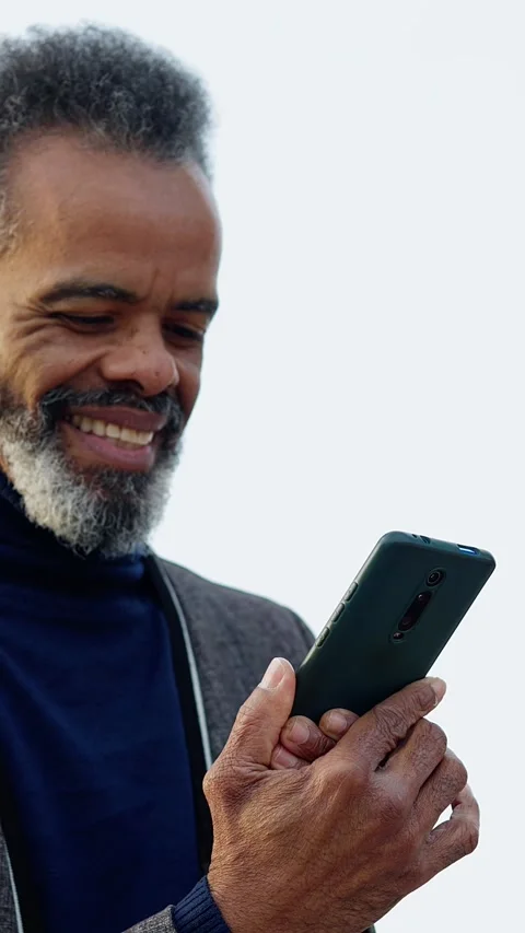 Happy senior black man using mobile phone outside Stock Footage 302838666
