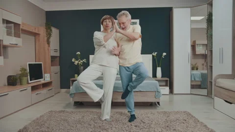 Happy senior couple having fun with yoga at home Vidéo 327453629