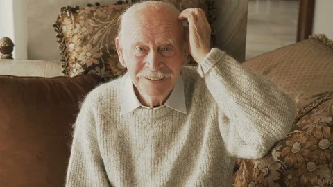 Happy senior elder man looking talking to camera recording vlog or making call Stock Footage 116326614