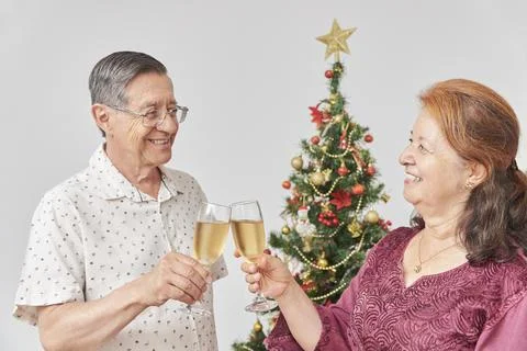 Happy senior hispanic couple toasting during Christmas or New Year Stock Photos