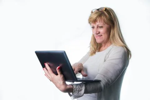 Happy senior lady using her laptop Stock Photos