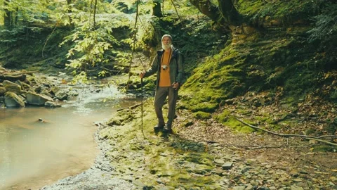 Happy Senior Man with a Backpack and Nordic Walking Sticks, Tourism Video stock 163761264