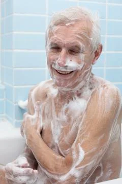 Happy senior man bathing Stock Photos