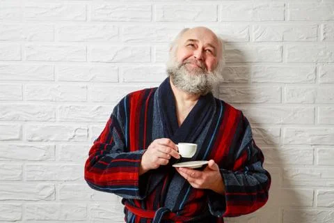 Happy Senior Man with Beard Drinking Coffee Stock Photos