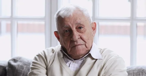 Happy senior man sit on sofa looking at camera, portrait Stock Footage 125529041