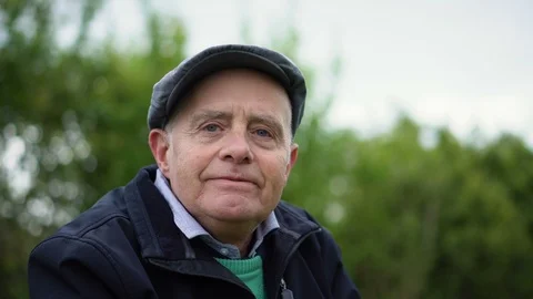 Happy Senior Man Smiling at Camera While Camera is Rotating - Nature Setting 4K Stock Footage 113083959