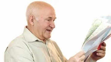 Happy senior man using a map smiling joyfully Stock Footage 85893482