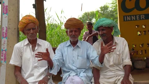 Happy senior men talking together some important topic for their village Stock Footage