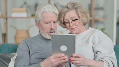 Happy Senior Old Couple using Tablet at Home Stock Footage 148202427