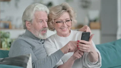 Happy Senior Old Couple using Smartphone Together at Home Stock Footage 148202898