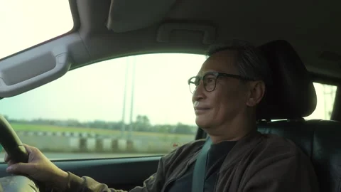 Happy Senior old man looking roadway while driving car in the morning. Stock Footage 274406553
