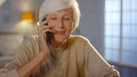 Happy Senior Woman Talking on Mobile Phone at Home Stock Footage