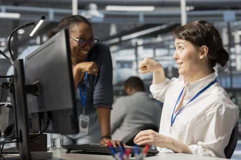 Happy server hub manager does fist bump with worker after completing operations Foto stock