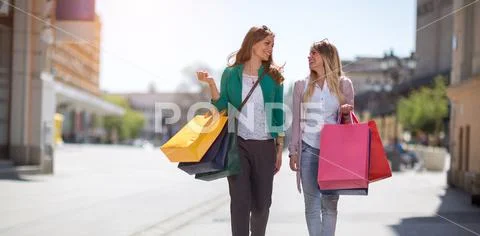 Happy shopaholics shopping. Stock Photos