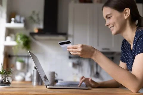 Happy shopper girl using laptop and credit card at home, Stock Photos