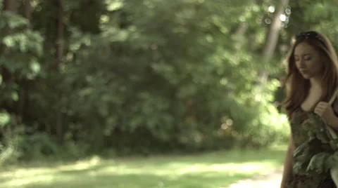 Happy shopper stops in a park 4K Stock Footage 41295612