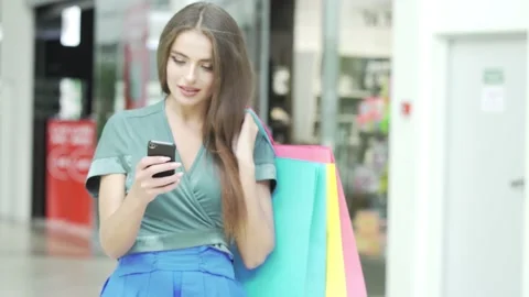 Happy shopping mall customer using phone Stock Footage 146588154