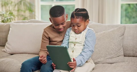 Happy, siblings and children on sofa with tablet for online game, streaming and Stock Footage 341456798