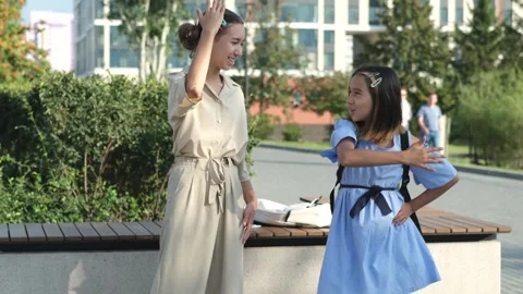 Happy sisters are learning a new dance and having fun in the park on a warm Stock Footage 253578778