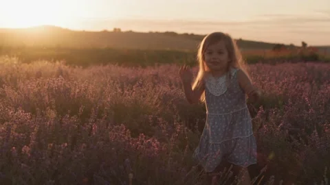 Happy small 3 year old blonde little girl dance on lavender field Video stock 138056440