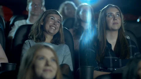 Happy, smiling and laughing movie theatre crowd enjoying a comedy film Stock Footage