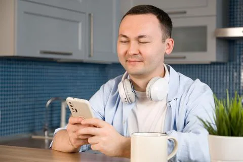 Happy smiling asiam man using smartphone for online shopping or communication Stock Photos