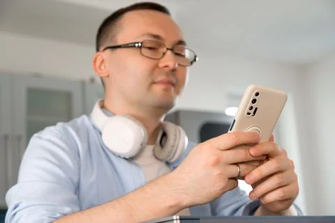 Happy smiling asian man using smartphone for online shopping or communication Stock Photos