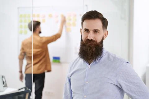 Happy smiling bearded senior developer or manager in modern IT office. Another Stock Photos