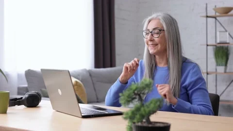 Happy smiling beautiful elderly gray-haired woman surprised by the good news and 스톡 동영상 213278482