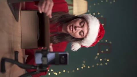 Happy smiling blogger with ring light and smartphone unboxing parcel box with 動画素材 255647739