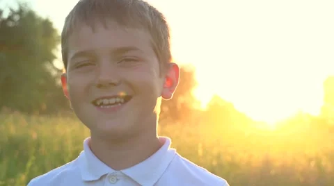 Happy smiling boy over sunset background Video stock 59081373