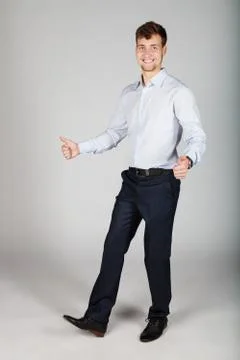 Happy smiling business man  in white shirt dancing showing his thumbs up. Stock Photos