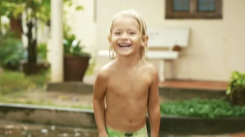 Happy smiling child having fun in the rain. Boy running through puddle. Stock-Footage 56141260