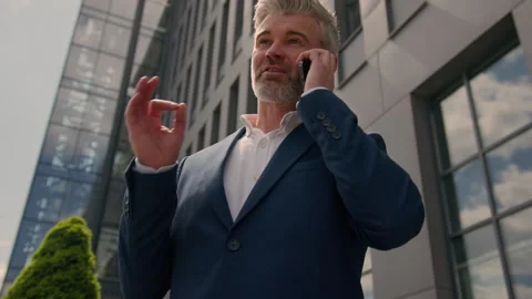 Happy smiling city building developer talk cellphone speaking calling joyful Stock Footage 254070179