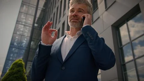 Happy smiling city building developer talk cellphone speaking calling joyful 스톡 사진