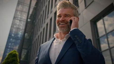 Happy smiling city building developer talk cellphone speaking calling joyful 스톡 사진