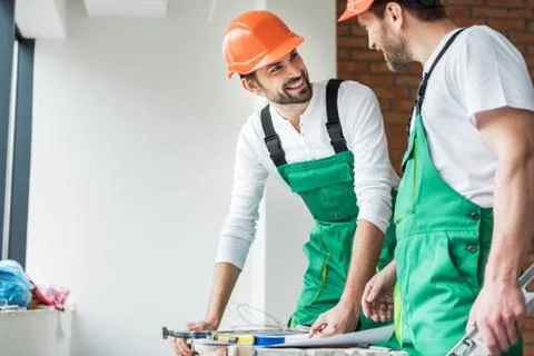 Happy smiling constructors working together Stock Photos