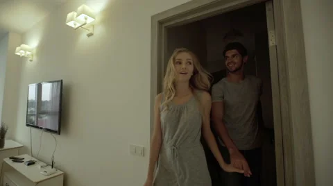 Happy smiling couple dancing in their beautiful new house Stock Footage 68721761