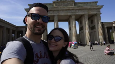 Happy Smiling Couple Taking Selfie Portrait, Brandenburg Gate, Berlin, Germany Stock Footage