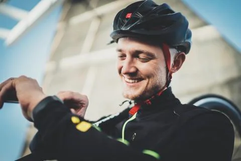 Happy smiling cyclist man checking fitness results Stock Photos