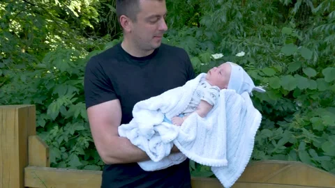 Happy smiling dad is looking on her newborn baby Stock Footage 201939391