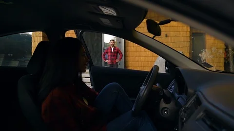 Happy smiling dark-haired woman getting out from the car and coming to joyful Stock Footage 121663175