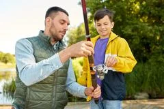The first joint fishing of adult father and teen son in warm