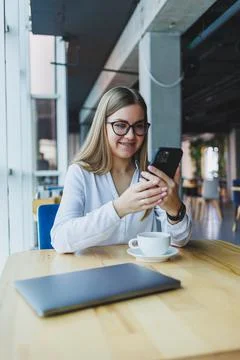 Happy smiling female manager using mobile phone gadget to check delivery serv Stock Photos