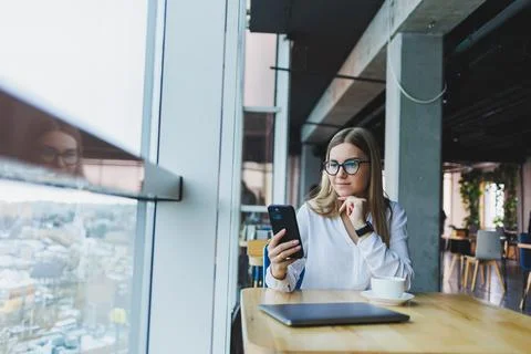 Happy smiling female manager using mobile phone gadget to check delivery serv Stock Photos