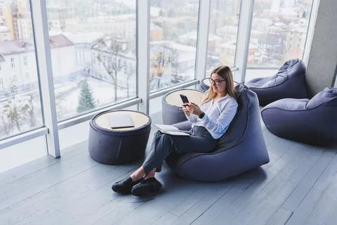 Happy smiling female manager using mobile phone gadget to check delivery serv Stock Photos